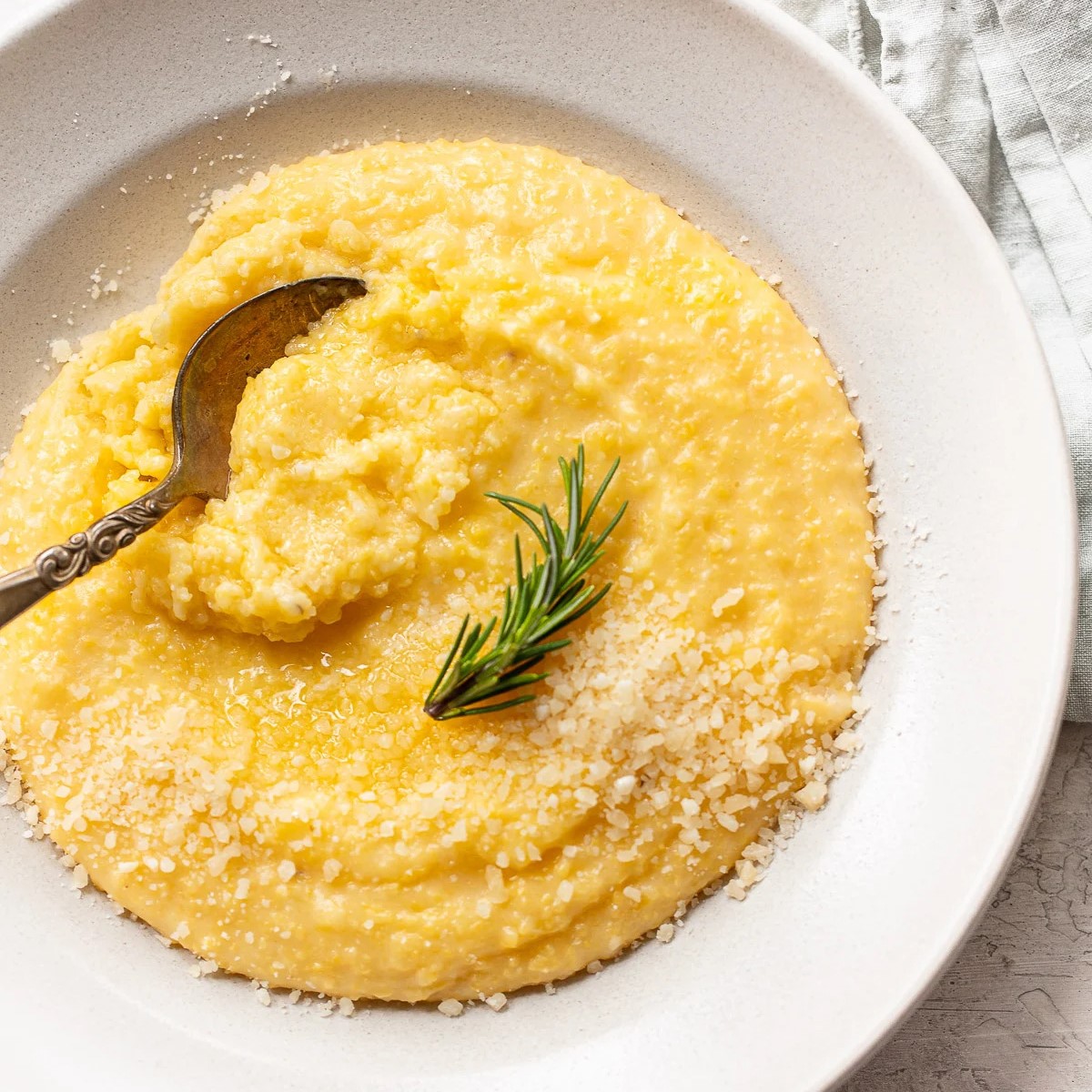 Overhead shot of a plate of polenta garnish with rosemary