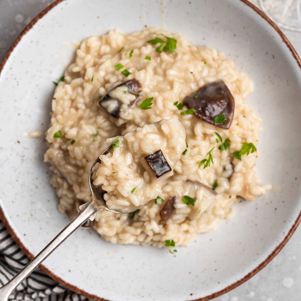 Overhead shot of a plate of mushroom risotto garnished with parsley